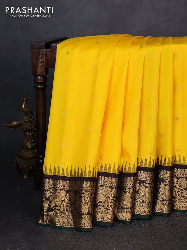 Pure gadwal silk saree yellow and coffee brown with allover zari woven buttas and temple zari woven border