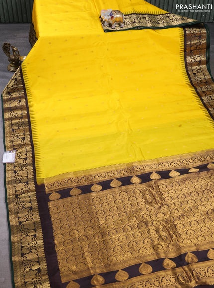 Pure gadwal silk saree yellow and coffee brown with allover zari woven buttas and temple zari woven border