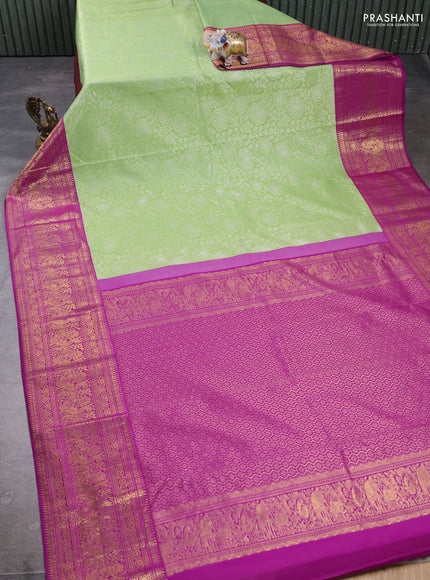 Kanchipuram silk saree light green and magenta pink with allover zari woven brocade weaves and long zari woven border