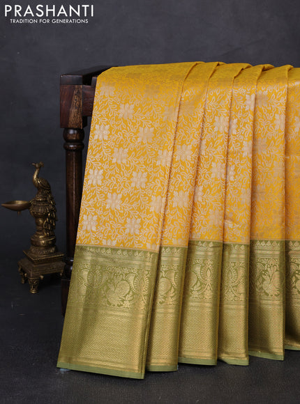 Kanchipuram silk saree mustard yellow and green shade with allover zari woven brocade weaves and long zari woven border