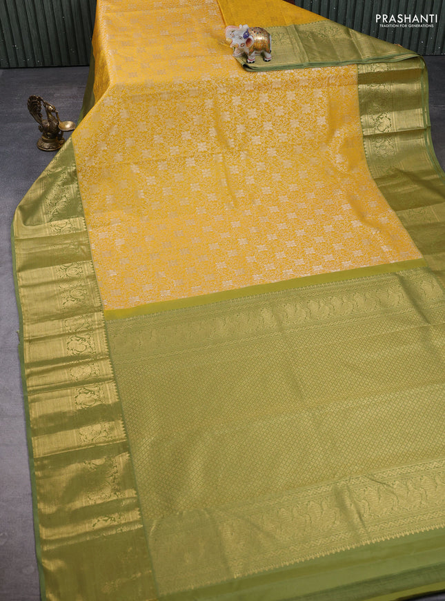 Kanchipuram silk saree mustard yellow and green shade with allover zari woven brocade weaves and long zari woven border