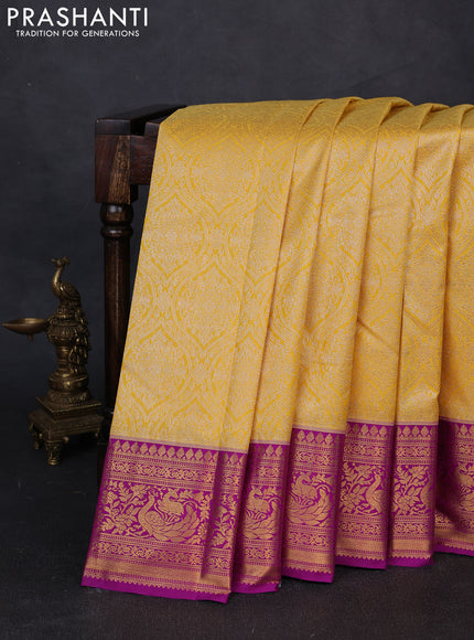 Kanchipuram silk saree mustard yellow and magenta pink with allover zari woven brocade weaves and zari woven border