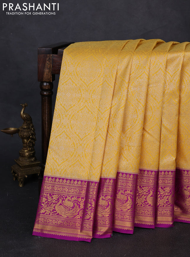 Kanchipuram silk saree mustard yellow and magenta pink with allover zari woven brocade weaves and zari woven border