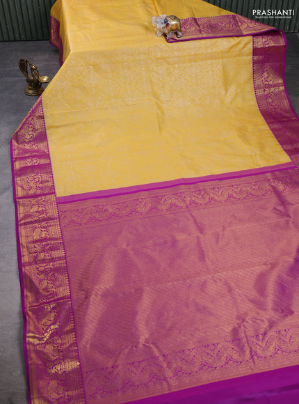 Kanchipuram silk saree mustard yellow and magenta pink with allover zari woven brocade weaves and zari woven border