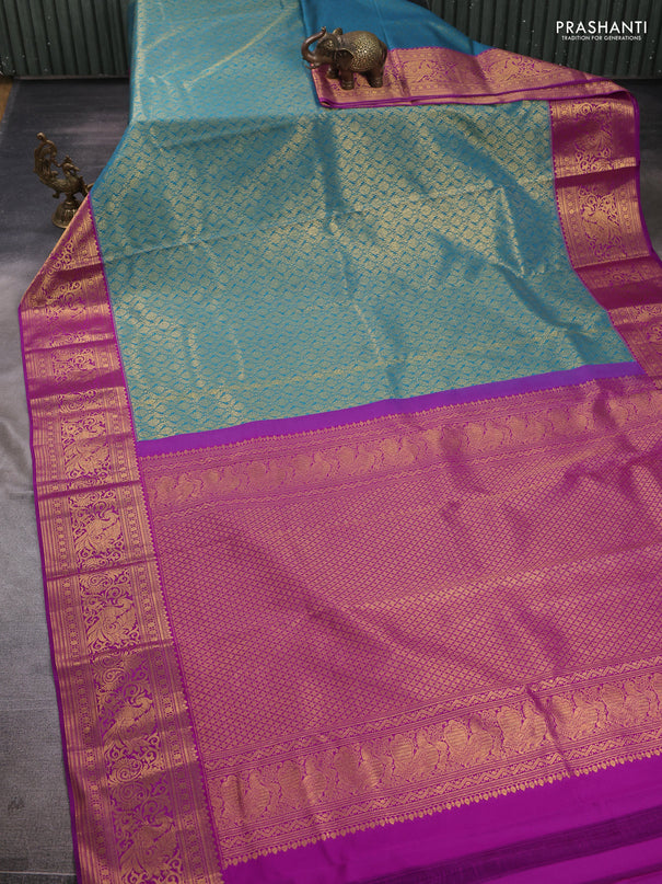 Kanchipuram silk saree teal blue and purple with allover zari woven brocade weaves and zari woven border