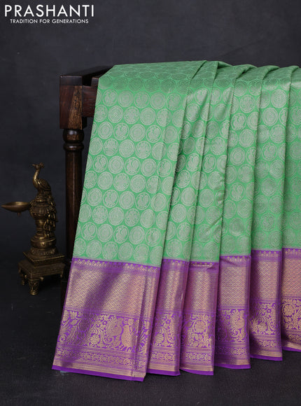 Kanchipuram silk saree light green and purple with allover zari woven brocade weaves and long zari woven border