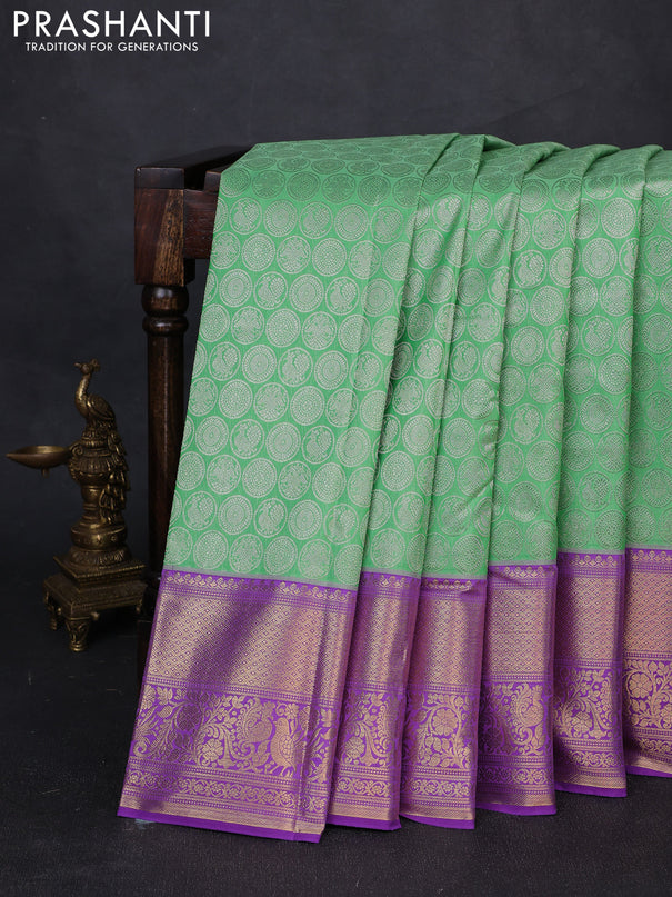 Kanchipuram silk saree light green and purple with allover zari woven brocade weaves and long zari woven border