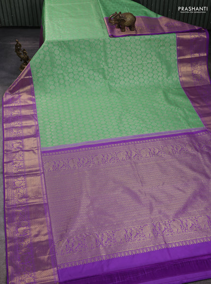 Kanchipuram silk saree light green and purple with allover zari woven brocade weaves and long zari woven border