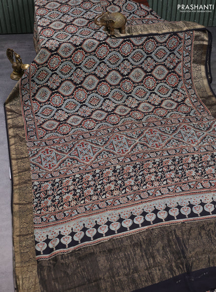Dola silk saree black and maroon with allover ajrakh prints and zari woven border