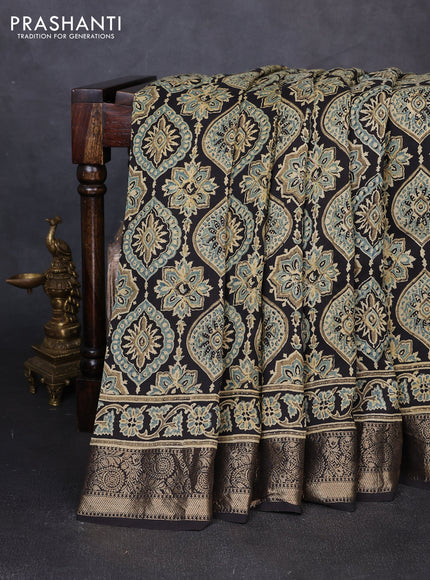 Dola silk saree black with allover ajrakh prints and zari woven border