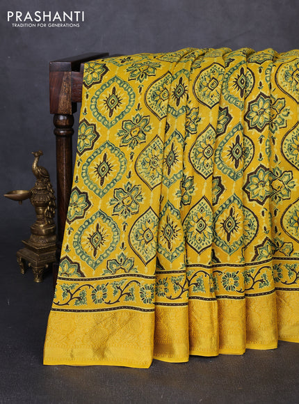 Dola silk saree yellow with allover ajrakh prints and zari woven border