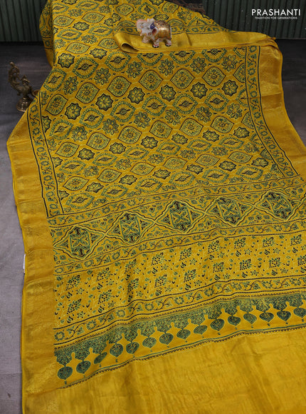 Dola silk saree yellow with allover ajrakh prints and zari woven border