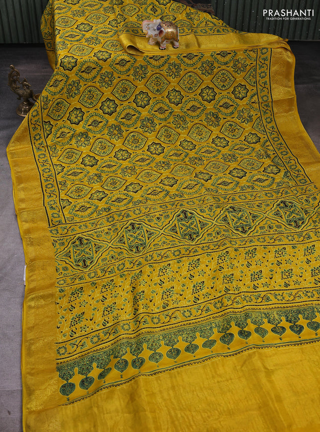 Dola silk saree yellow with allover ajrakh prints and zari woven border