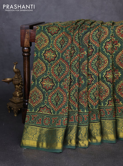 Dola silk saree green shade with allover ajrakh prints and zari woven border