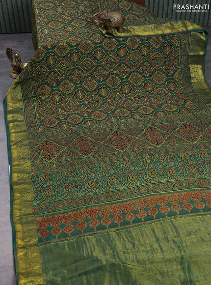 Dola silk saree green shade with allover ajrakh prints and zari woven border