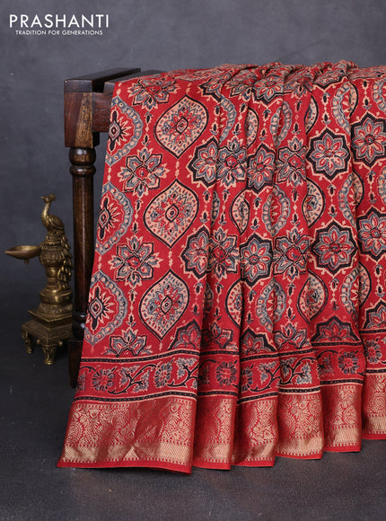 Dola silk saree maroon with allover ajrakh prints and zari woven border