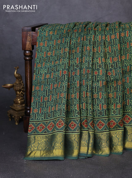 Dola silk saree green shade with allover ajrakh prints and zari woven border