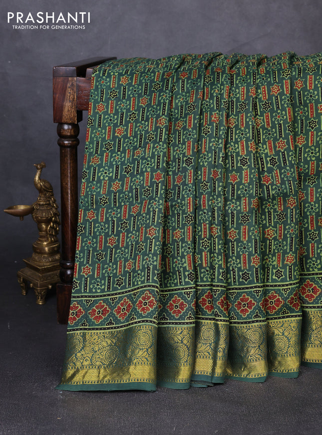 Dola silk saree green shade with allover ajrakh prints and zari woven border