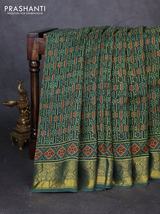 Dola silk saree green shade with allover ajrakh prints and zari woven border