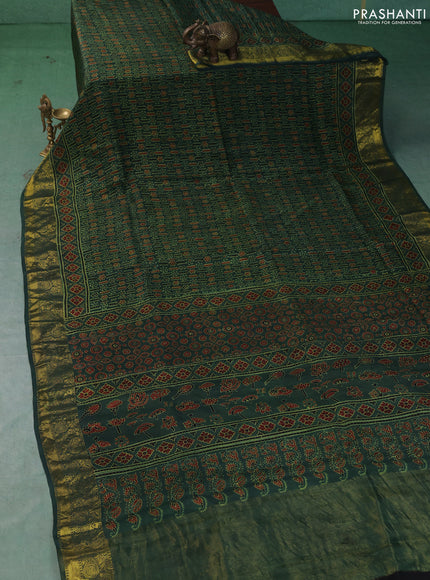 Dola silk saree green shade with allover ajrakh prints and zari woven border