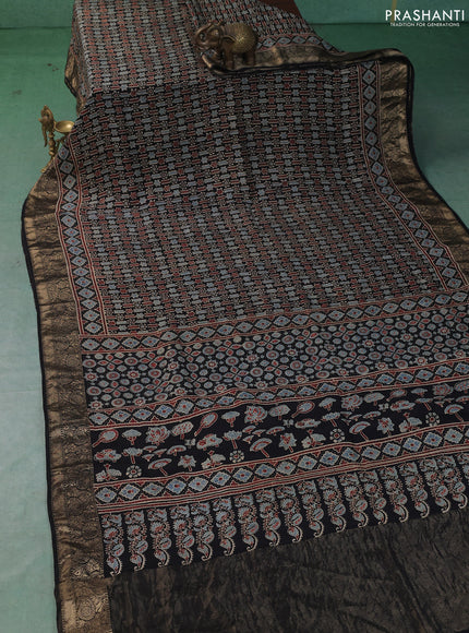 Dola silk saree black with allover ajrakh prints and zari woven border
