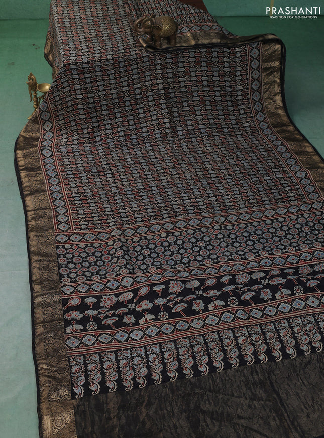 Dola silk saree black with allover ajrakh prints and zari woven border