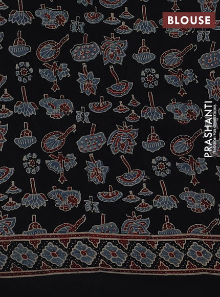 Dola silk saree black with allover ajrakh prints and zari woven border