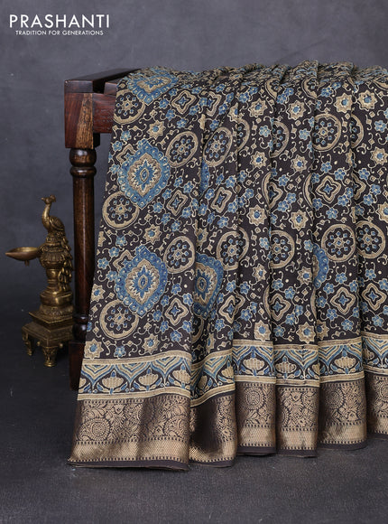 Dola silk saree black with allover ajrakh prints and zari woven border