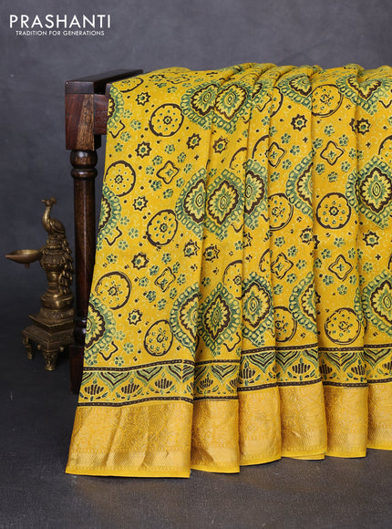 Dola silk saree yellow with allover ajrakh prints and zari woven border