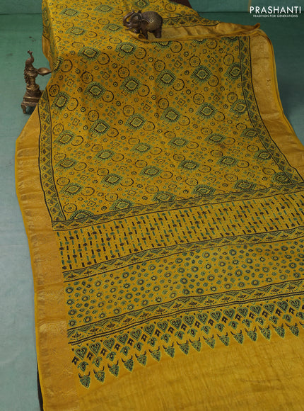 Dola silk saree yellow with allover ajrakh prints and zari woven border