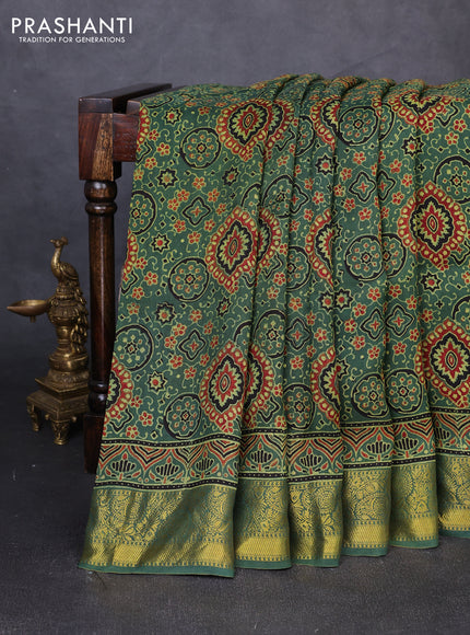 Dola silk saree green shade with allover ajrakh prints and zari woven border