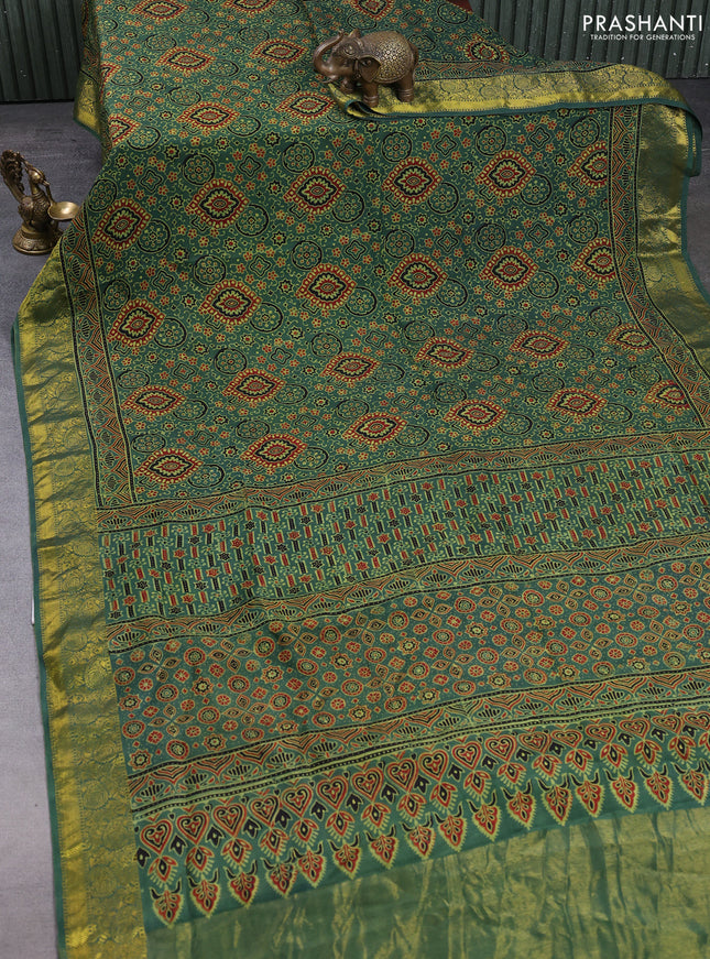 Dola silk saree green shade with allover ajrakh prints and zari woven border