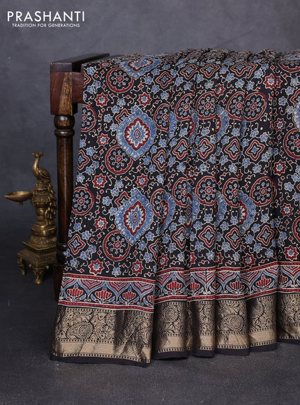 Dola silk saree black with allover ajrakh prints and zari woven border