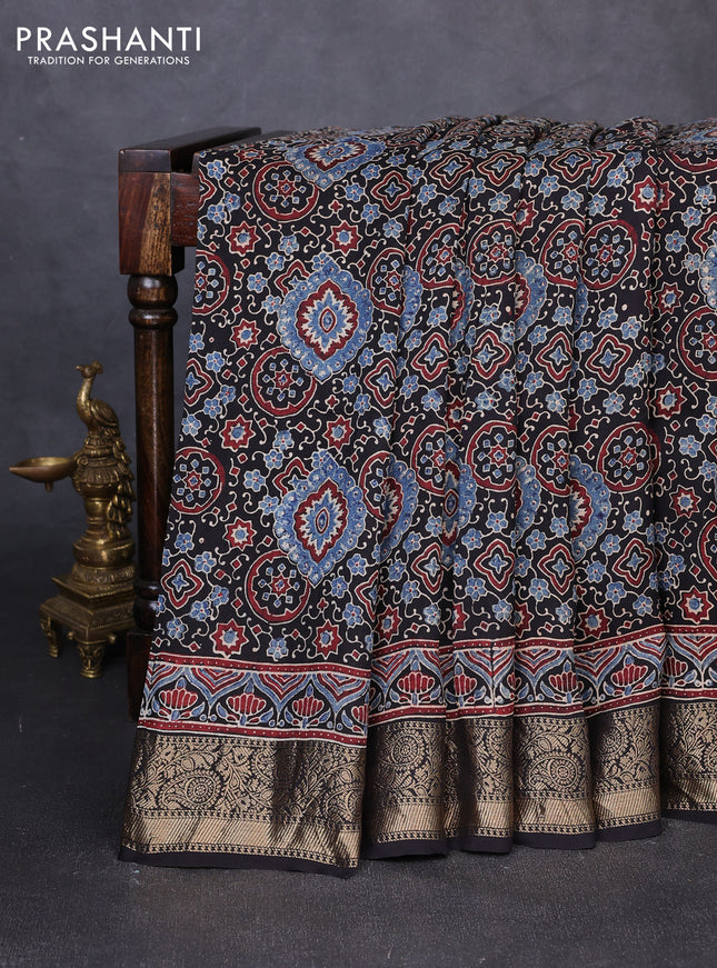 Dola silk saree black with allover ajrakh prints and zari woven border