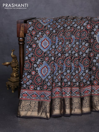 Dola silk saree black with allover ajrakh prints and zari woven border