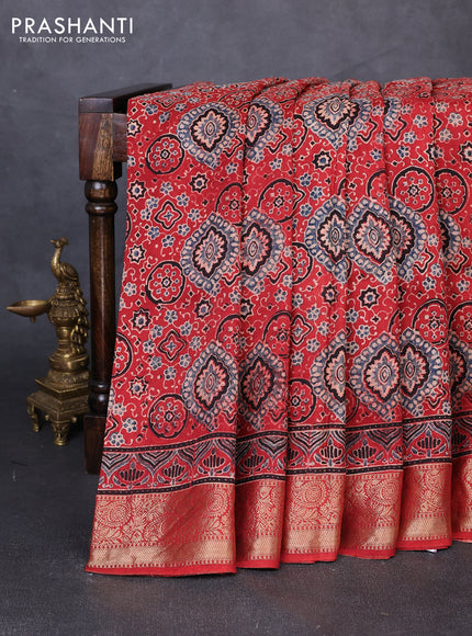 Dola silk saree maroon with allover ajrakh prints and zari woven border
