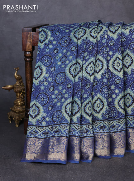 Dola silk saree blue shade with allover ajrakh prints and zari woven border
