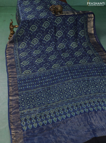 Dola silk saree blue shade with allover ajrakh prints and zari woven border