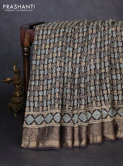 Dola silk saree black with allover ajrakh prints and zari woven border