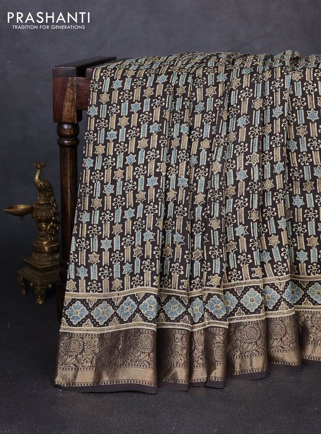 Dola silk saree black with allover ajrakh prints and zari woven border