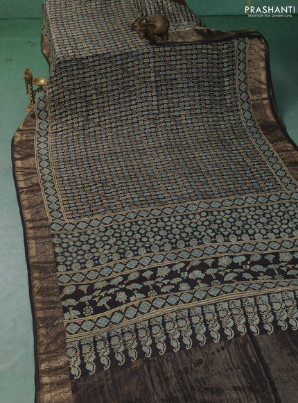 Dola silk saree black with allover ajrakh prints and zari woven border