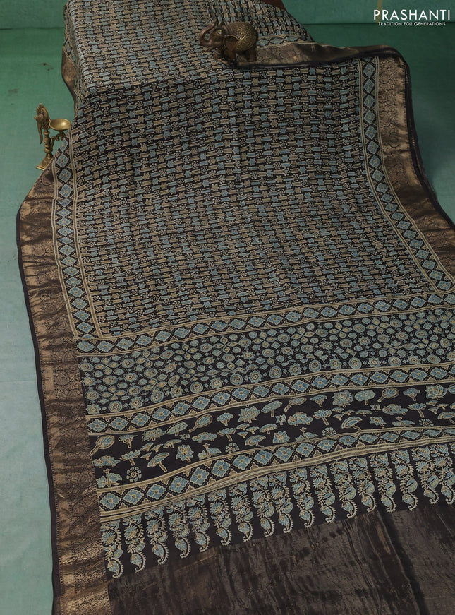 Dola silk saree black with allover ajrakh prints and zari woven border