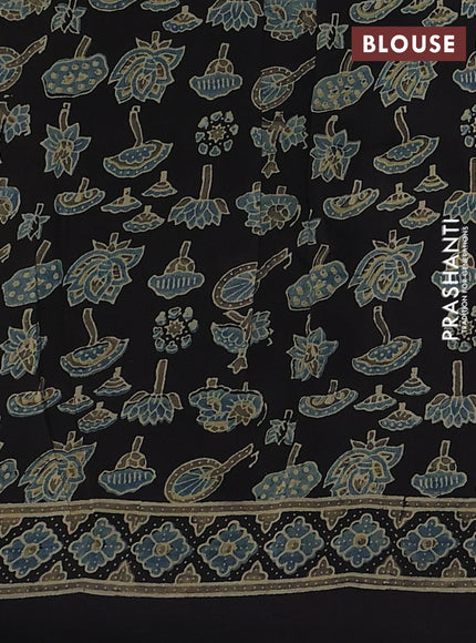 Dola silk saree black with allover ajrakh prints and zari woven border