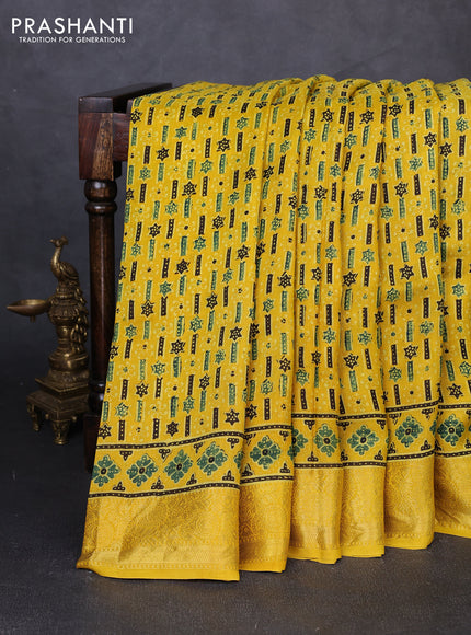 Dola silk saree yellow with allover ajrakh prints and zari woven border