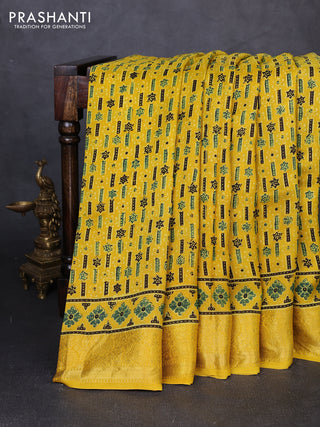 Dola silk saree yellow with allover ajrakh prints and zari woven border