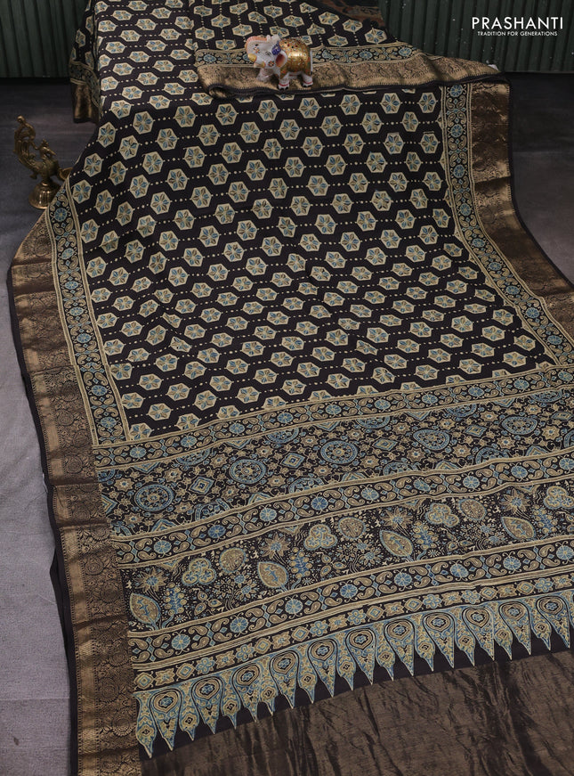 Dola silk saree black with allover ajrakh butta prints and zari woven border