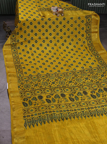 Dola silk saree yellow with allover ajrakh butta prints and zari woven border