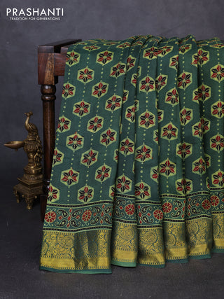 Dola silk saree green shade with allover ajrakh butta prints and zari woven border