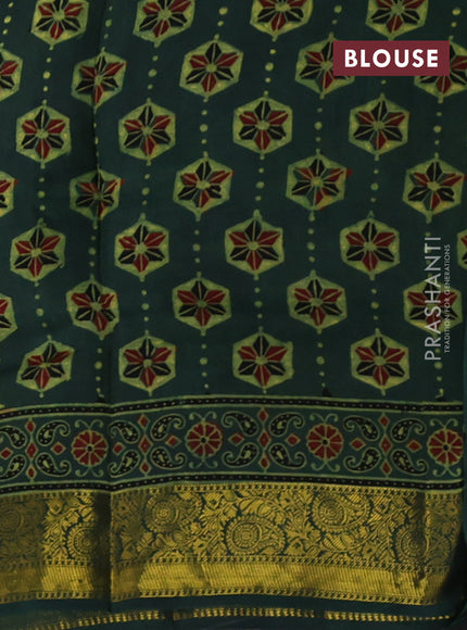 Dola silk saree green shade with allover ajrakh butta prints and zari woven border