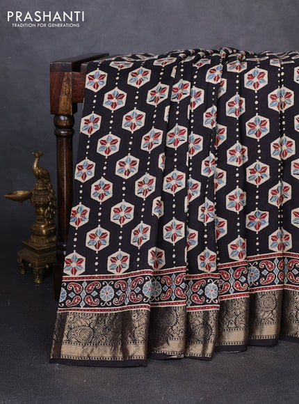 Dola silk saree black and blue shade with allover ajrakh butta prints and zari woven border